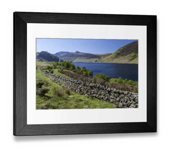 Framed Print : View over an old English stone wall towards the blue lake of Crummock Water, Lake District National Park, Cumbria, England, United Kingdom
