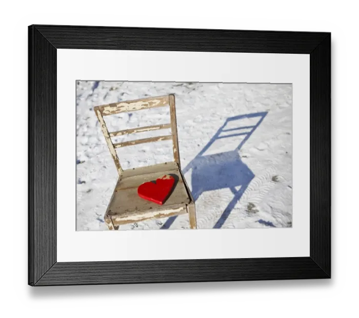 Framed Print : Red wooden heart placed on an old chair in snow Framed Print : Red wooden heart placed on an old chair in snow