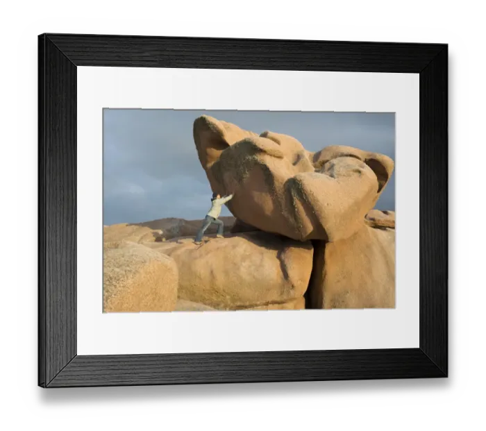 Framed Print : Woman supporting a huge boulder as a joke, evening light, Cote de Granit Rose, Brittany, France, Europe Framed Print : Woman supporting a huge boulder as a joke, evening light, Cote de Granit Rose, Brittany, France, Europe