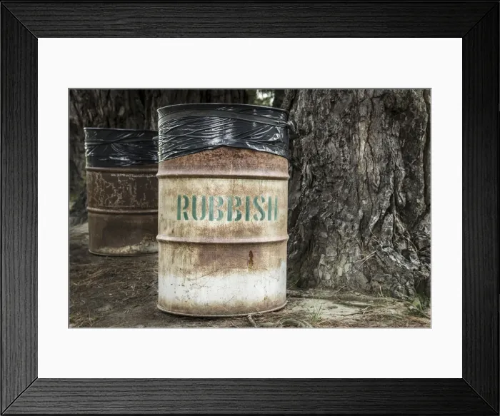 Framed Print : Rusty tin rubbish bin with word rubbish next to a gnarled tree, New Zealand Framed Print : Rusty tin rubbish bin with word rubbish next to a gnarled tree, New Zealand