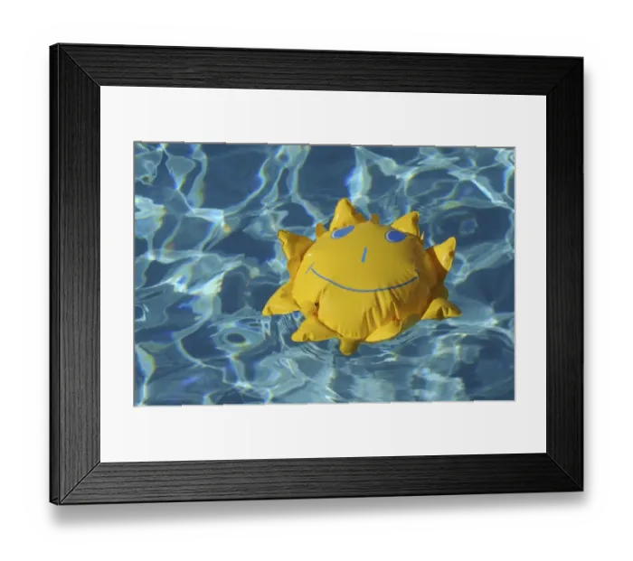 Framed Print : Toy sun floating in a swimming pool Framed Print : Toy sun floating in a swimming pool