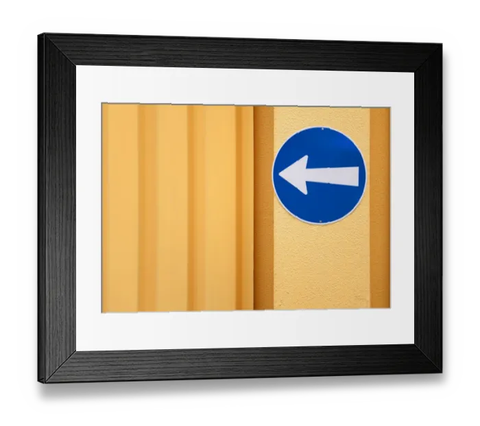 Framed Print : Traffic sign, arrow to the left, on the wall of a building Framed Print : Traffic sign, arrow to the left, on the wall of a building