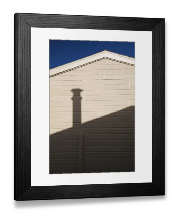Framed Print : Roofline and chimney shadow on the exterior side wall of a residential home, Quebec, Canada Framed Print : Roofline and chimney shadow on the exterior side wall of a residential home, Quebec, Canada
