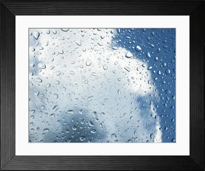 Framed Print : Raindrops on a window in front of storm clouds
