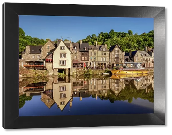 The picturesque medieval port of Dinan, reflected in the smooth Rance, Rance Estuary, Brittany, France