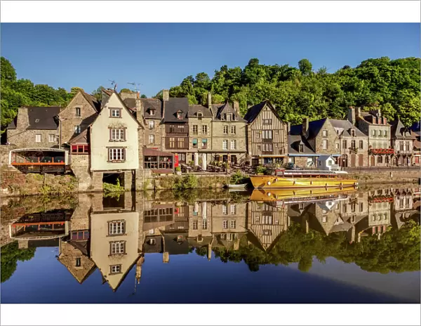 The picturesque medieval port of Dinan, reflected in the smooth Rance, Rance Estuary, Brittany, France