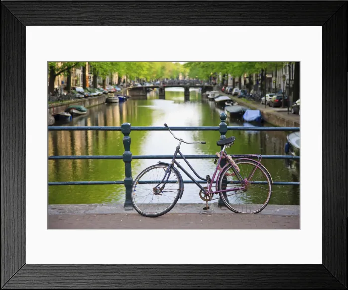 Framed Print : Bicycle on a bridge crossing a canal in the historic city centre of Amsterdam, Holland, Netherlands, Europe
