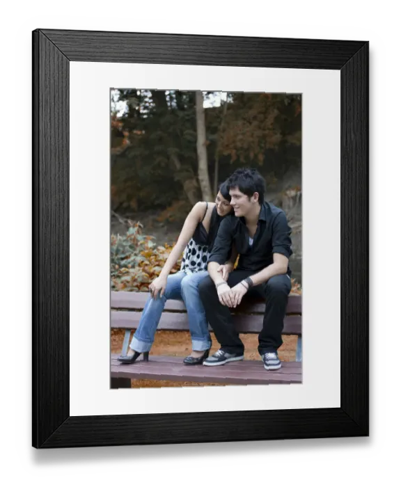 Framed Print : Couple of Southern European origin, sitting on the back of a park bench Framed Print : Couple of Southern European origin, sitting on the back of a park bench