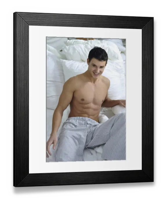 Framed Print : Bare-chested young man wearing pyjama bottoms lying in bed Framed Print : Bare-chested young man wearing pyjama bottoms lying in bed