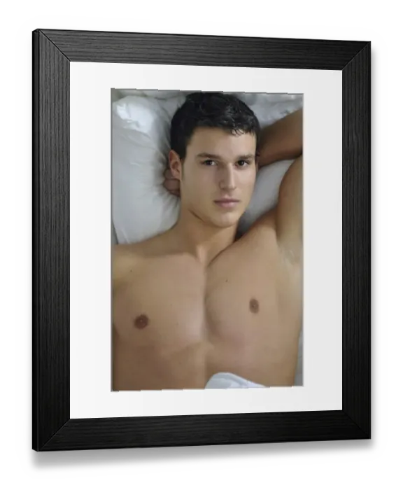 Framed Print : Bare-chested young man lying in bed Framed Print : Bare-chested young man lying in bed