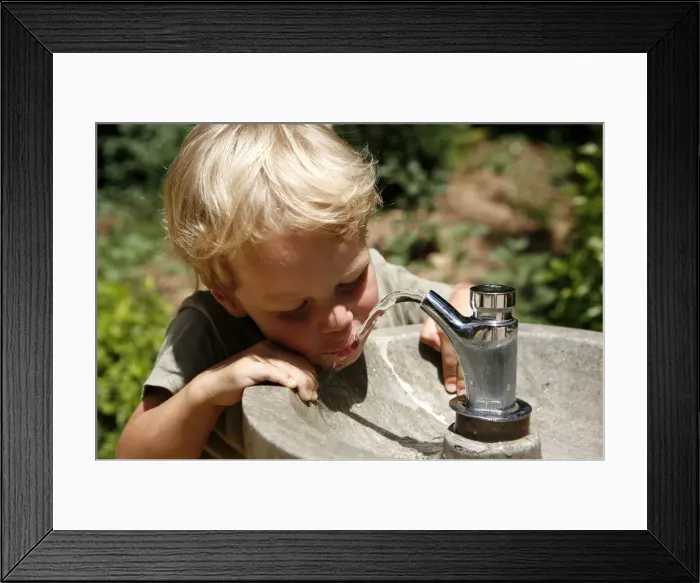 Framed Print : Boy, three years, drinking water from a public tap, Spain, Europe