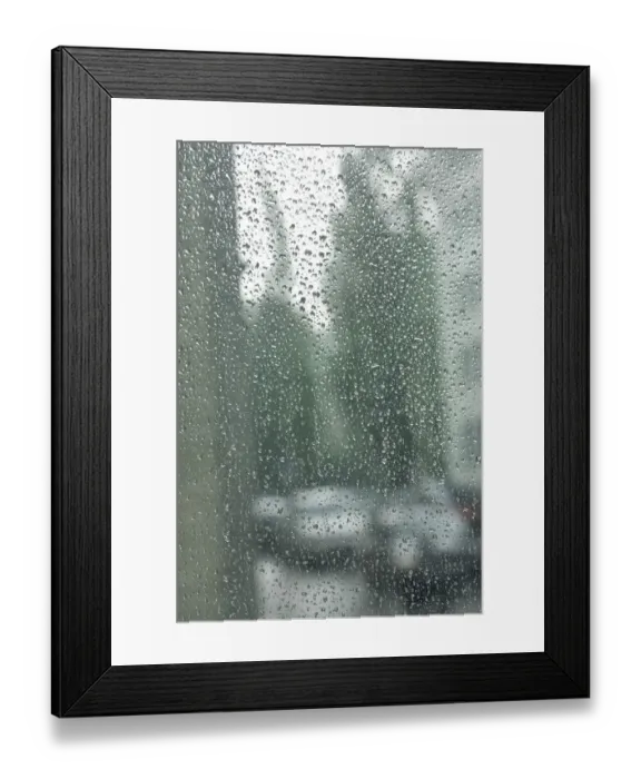 Framed Print : Rain drops on a window pane, blurry buildings and cars in the back Framed Print : Rain drops on a window pane, blurry buildings and cars in the back