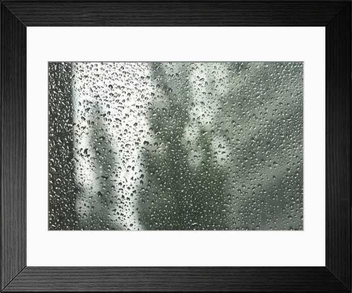 Framed Print : Rain drops on a window pane, blurry buildings in the back Framed Print : Rain drops on a window pane, blurry buildings in the back