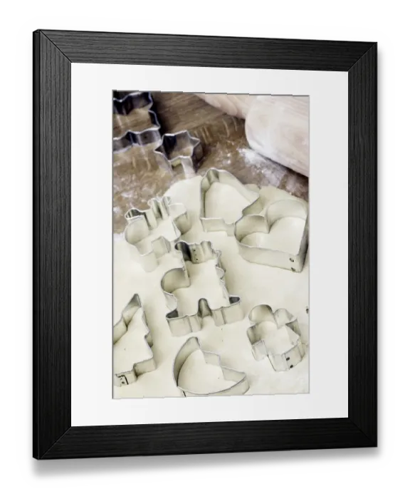 Framed Print : Making Christmas cookies with dough and cookie cutters
