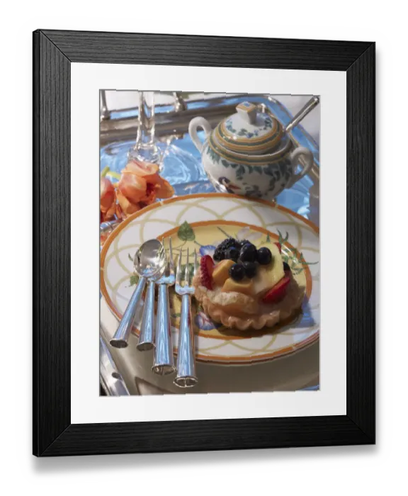 Framed Print : Fruit tart on a decorative plate with silver cutlery and a stylish ambience Framed Print : Fruit tart on a decorative plate with silver cutlery and a stylish ambience