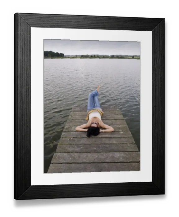 Framed Print : Woman relaxing lying on a wooden pier at a lake, Mecklenburg Lake District, Mecklenburg-Western Pomerania, Germany, Europe Framed Print : Woman relaxing lying on a wooden pier at a lake, Mecklenburg Lake District, Mecklenburg-Western Pomerania, Germany, Europe