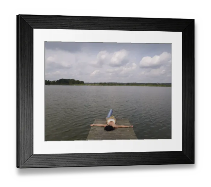 Framed Print : Woman relaxing lying on a wooden pier at a lake, Mecklenburg Lake District, Mecklenburg-Western Pomerania, Germany, Europe Framed Print : Woman relaxing lying on a wooden pier at a lake, Mecklenburg Lake District, Mecklenburg-Western Pomerania, Germany, Europe
