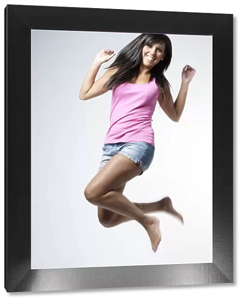 Young woman jumping for joy in the air