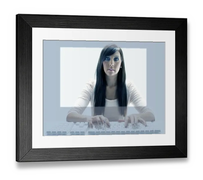 Framed Print : Young woman seen through the display of a computer while using the keyboard Framed Print : Young woman seen through the display of a computer while using the keyboard