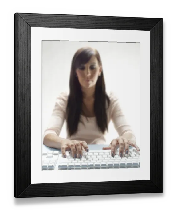 Framed Print : Young woman using a keyboard Framed Print : Young woman using a keyboard