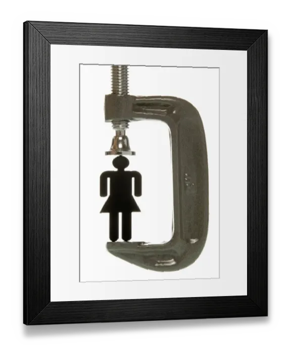 Framed Print : Small black female figurine in a screw clamp, symbolic image for being under pressure to perform Framed Print : Small black female figurine in a screw clamp, symbolic image for being under pressure to perform