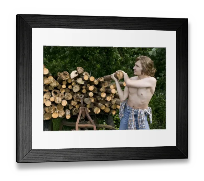 Framed Print : Farmer lifting a log Framed Print : Farmer lifting a log