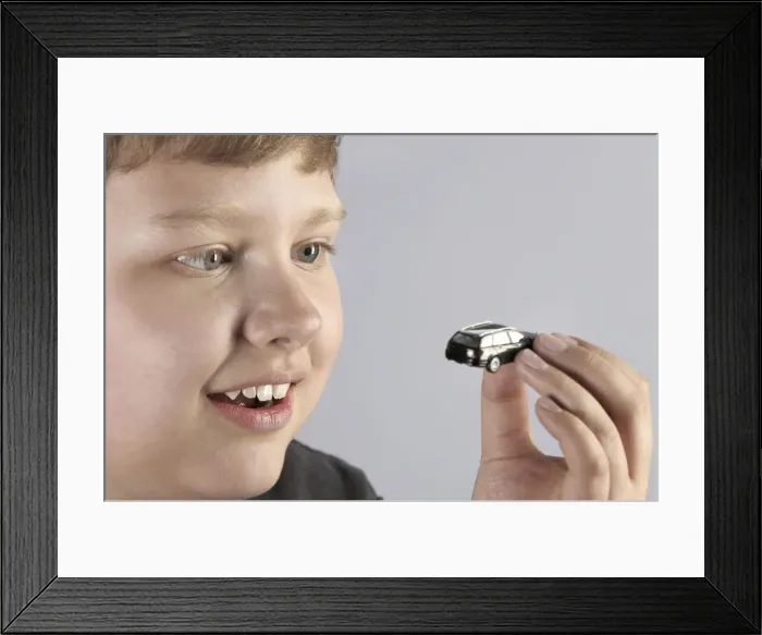 Framed Print : Boy with a car model Framed Print : Boy with a car model