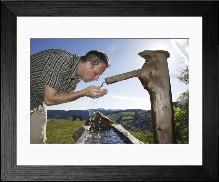 Framed Print : A man in his mid 40s cools off at a well, Todtnauberg in the Black Forest, Baden-Wuerttemberg, Germany, Europe Framed Print : A man in his mid 40s cools off at a well, Todtnauberg in the Black Forest, Baden-Wuerttemberg, Germany, Europe