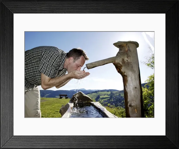 Framed Print : A man in his mid 40 quenches his thirst at a well, Todtnauberg in the Black Forest, Baden-Wuerttemberg, Germany, Europe Framed Print : A man in his mid 40 quenches his thirst at a well, Todtnauberg in the Black Forest, Baden-Wuerttemberg, Germany, Europe