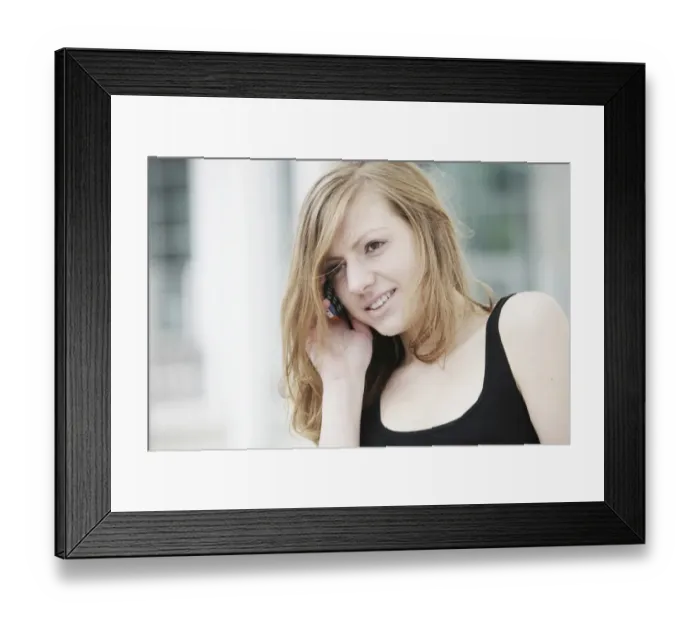Framed Print : Young woman speaking on her mobile phone, smiling Framed Print : Young woman speaking on her mobile phone, smiling
