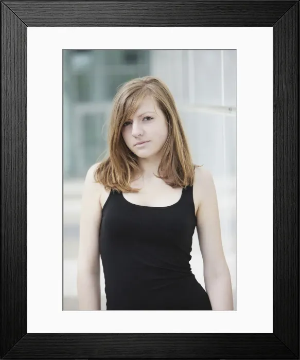 Framed Print : Sensual portrait of a young long-haired woman in a black tank top Framed Print : Sensual portrait of a young long-haired woman in a black tank top