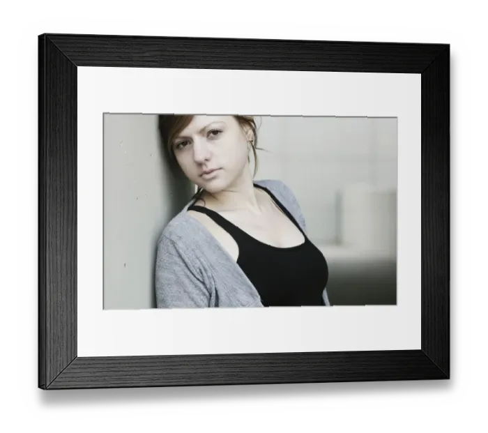 Framed Print : Young woman leaning against a wall Framed Print : Young woman leaning against a wall