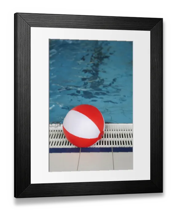 Framed Print : Beach ball at the edge of a swimming pool Framed Print : Beach ball at the edge of a swimming pool