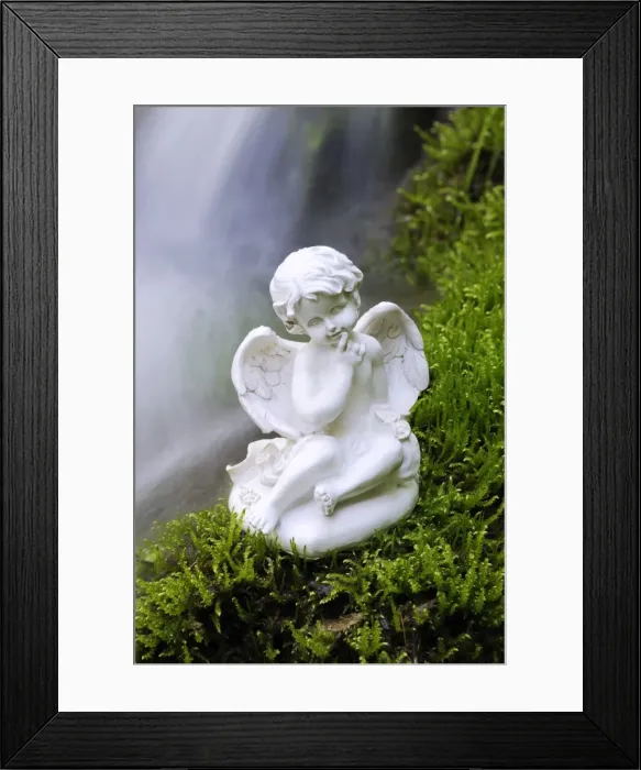 Framed Print : Porcelain angel figure on moss at a waterfall Framed Print : Porcelain angel figure on moss at a waterfall