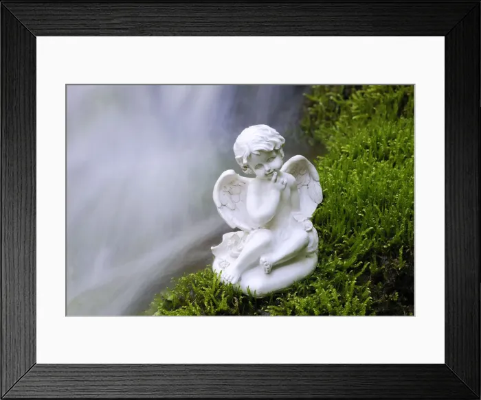 Framed Print : Porcelain angel figure on moss at a waterfall Framed Print : Porcelain angel figure on moss at a waterfall