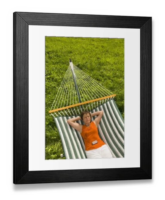 Framed Print : Senior woman listening to music in a hammock Framed Print : Senior woman listening to music in a hammock