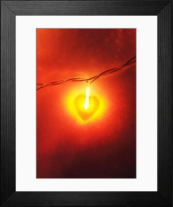 Framed Print : Lit heart-shaped fairy lights in the snow