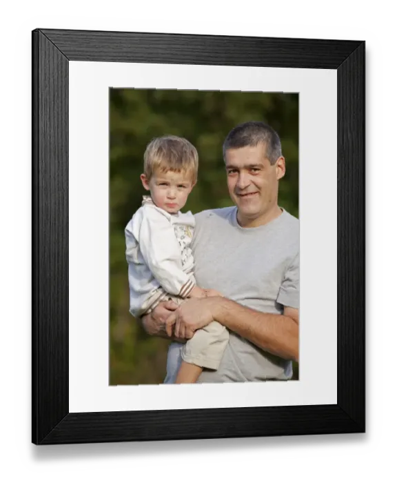 Framed Print : Father carrying his young son in his arms Framed Print : Father carrying his young son in his arms