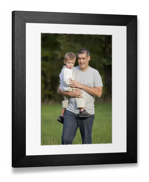 Framed Print : Father carrying his young son in his arms