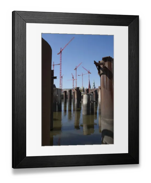 Framed Print : Steel pillars in the water in front of construction cranes in the new development area of HafenCity, Hamburg, Germany, Europe Framed Print : Steel pillars in the water in front of construction cranes in the new development area of HafenCity, Hamburg, Germany, Europe