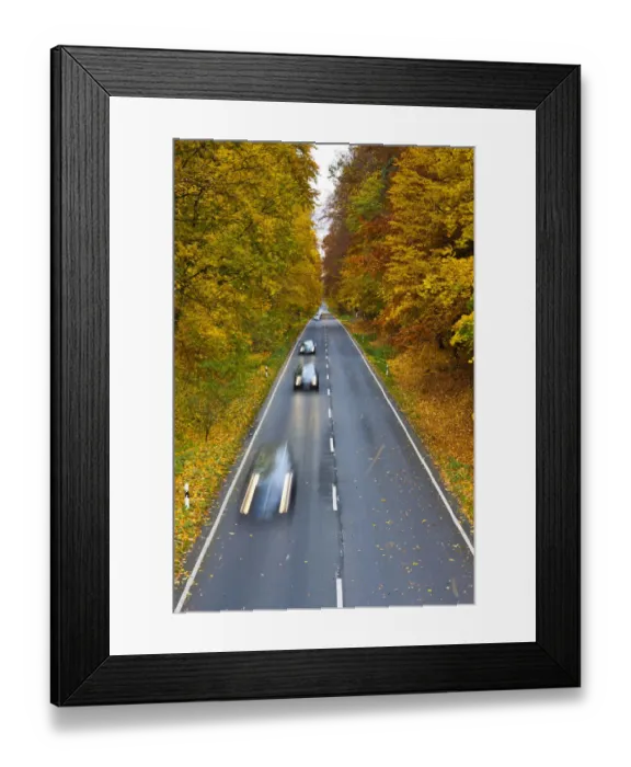 Framed Print : Cars driving on a country road in autumn, Hesse, Germany, Europe Framed Print : Cars driving on a country road in autumn, Hesse, Germany, Europe