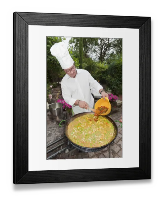 Framed Print : Cook preparing a paella, a Spanish rice dish, adding peppers, series, no. 2 Framed Print : Cook preparing a paella, a Spanish rice dish, adding peppers, series, no. 2