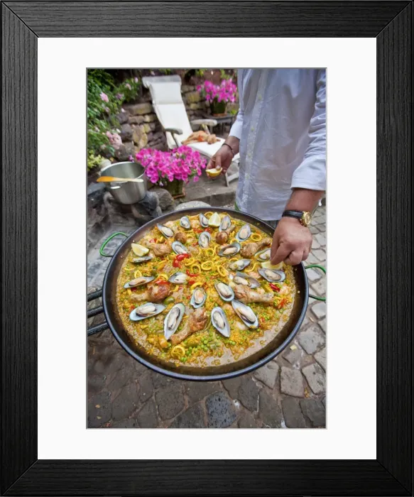 Framed Print : Cook preparing a paella, a Spanish rice dish, adding lemon, series, no. 6