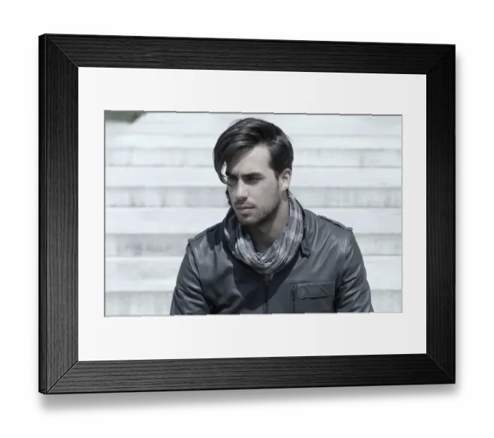 Framed Print : Young man wearing a leather jacket in front of an open staircase, portrait Framed Print : Young man wearing a leather jacket in front of an open staircase, portrait