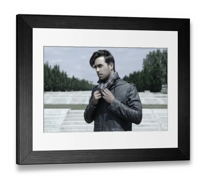 Framed Print : Young man wearing a leather jacket in front of an open staircase, portrait Framed Print : Young man wearing a leather jacket in front of an open staircase, portrait