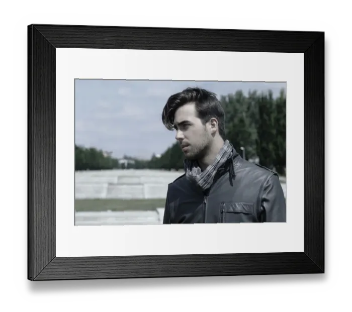 Framed Print : Young man wearing a leather jacket in front of an open staircase, portrait Framed Print : Young man wearing a leather jacket in front of an open staircase, portrait