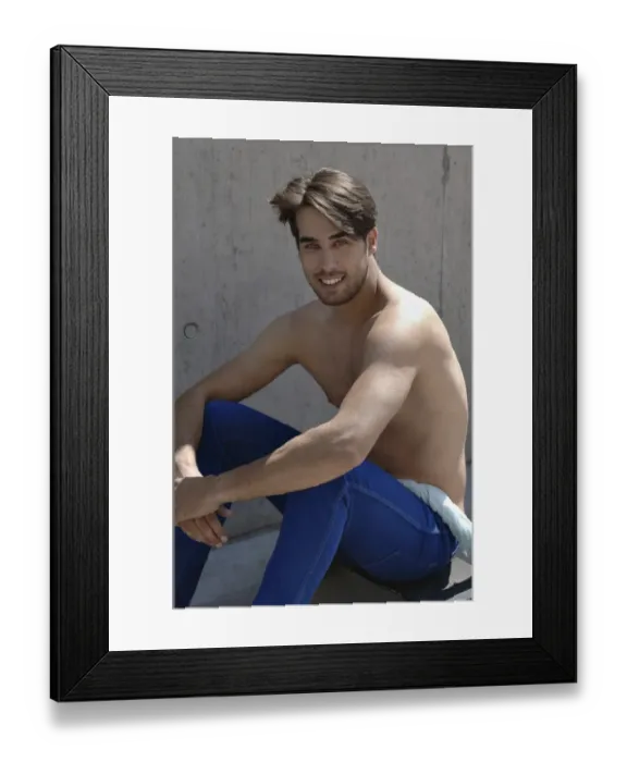 Framed Print : Young shirtless skater in front of a concrete wall, sitting on his skateboard Framed Print : Young shirtless skater in front of a concrete wall, sitting on his skateboard