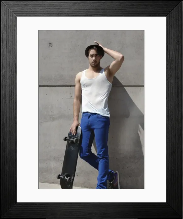 Framed Print : Young skater in front of a concrete wall Framed Print : Young skater in front of a concrete wall