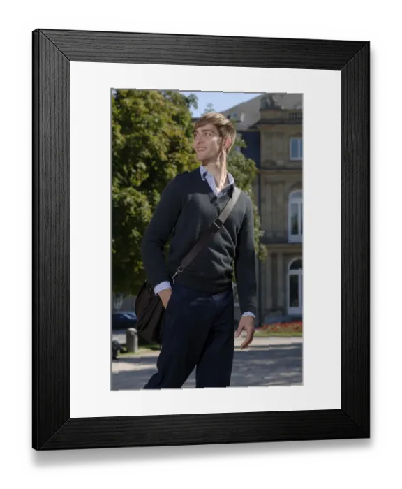 Framed Print : Young man wearing elegant clothing with a bag over his shoulder in front of the New Palace in Stuttgart, Baden-Wuerttemberg, Germany, Europe