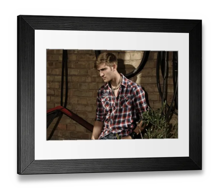 Framed Print : Young man wearing a plaid shirt in a backyard Framed Print : Young man wearing a plaid shirt in a backyard